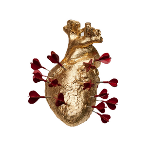 a gold anatomical heart with red darts stuck into it